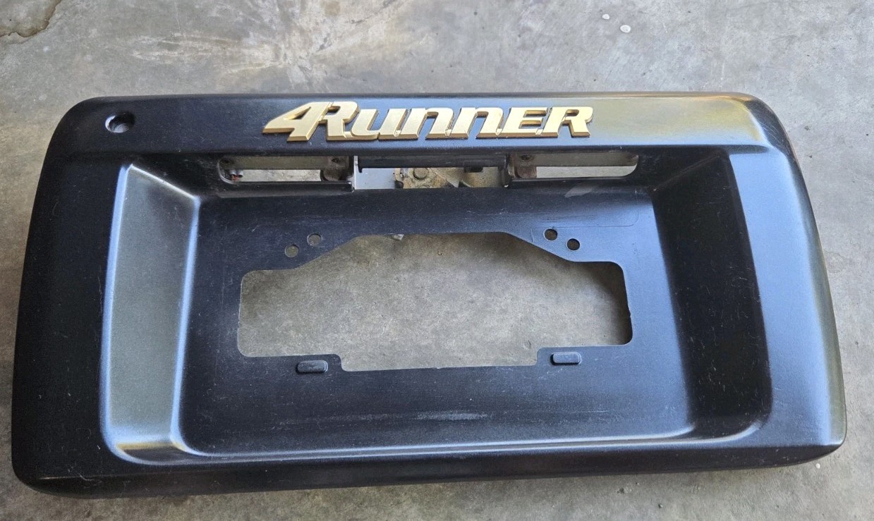 1996-2002 TOYOTA 4RUNNER REAR HATCH LICENSE PLATE HOLDER PANEL GOLD EMBLEM OEM. 1996-2002 TOYOTA 4RUNNER REAR HATCH LICENSE PLATE HOLDER PANEL GOLD EMBLEM OEM.