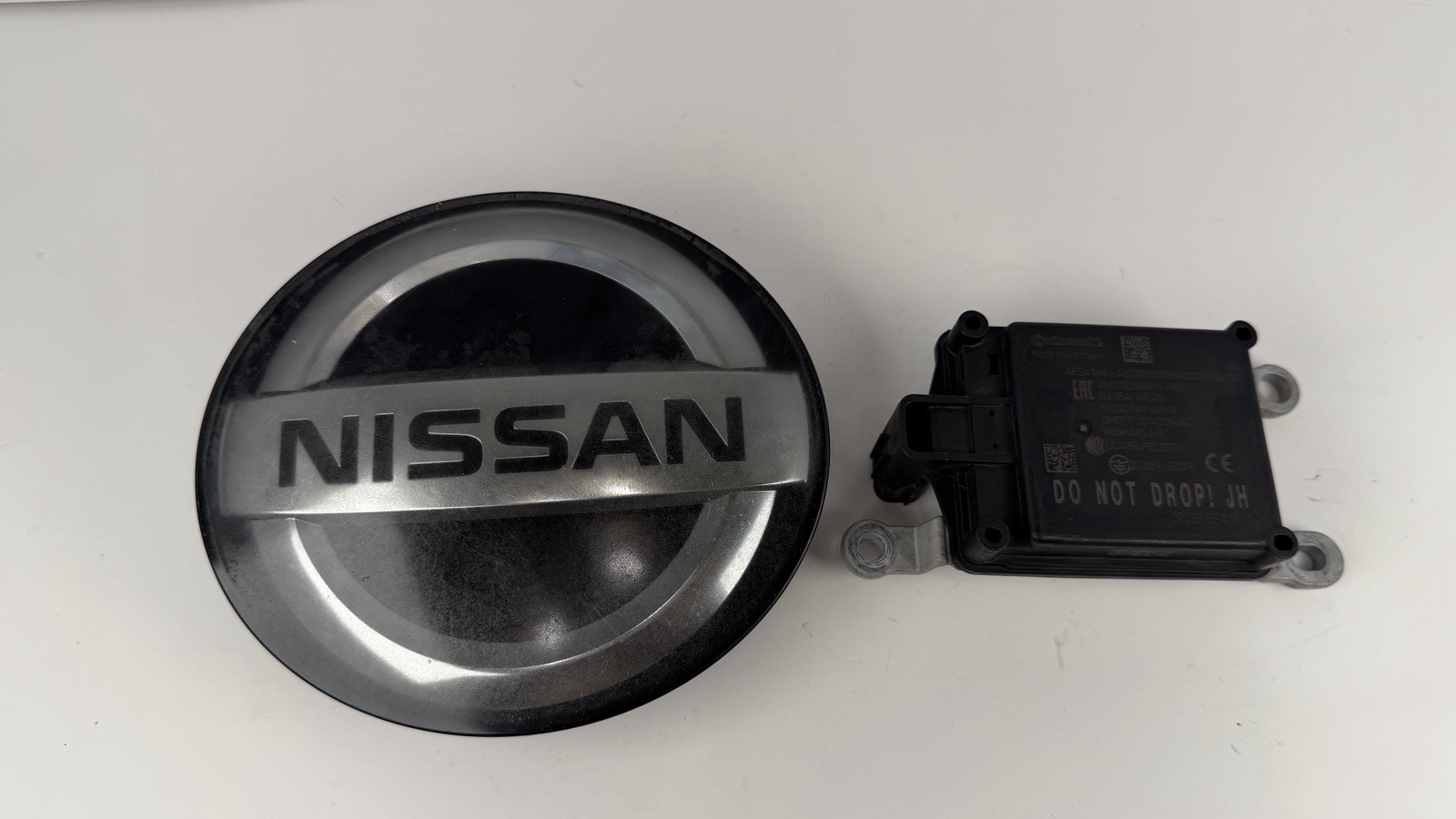 2017-2019 Nissan Rogue Front Radar Sensor Emblem OEM 28438-5FA1A 62890-7FW0A