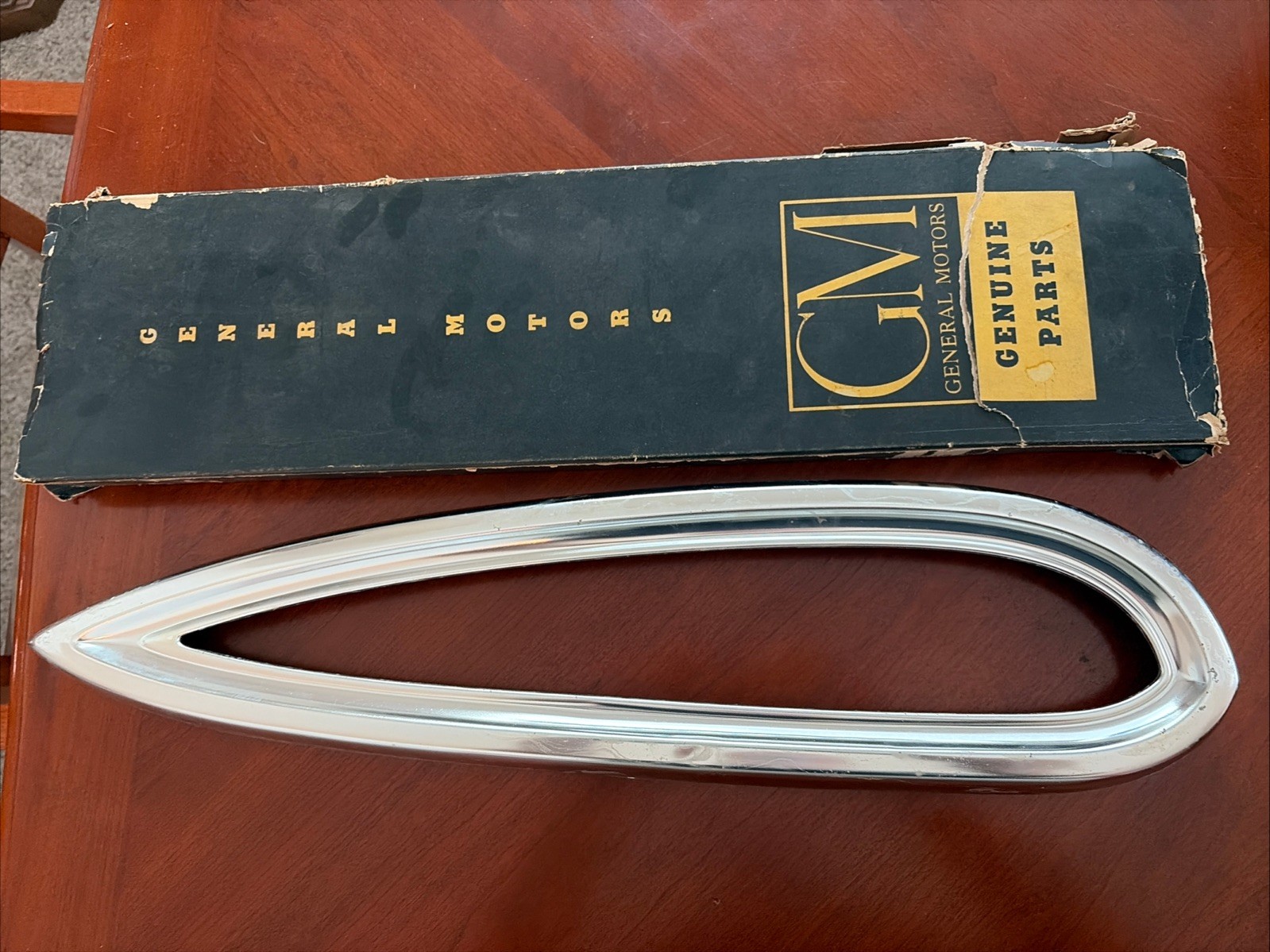 1959 Chevy tail lite bezel in GM box dented NOS Driver Side 1959 Chevy tail lite bezel in GM box dented NOS Driver Side